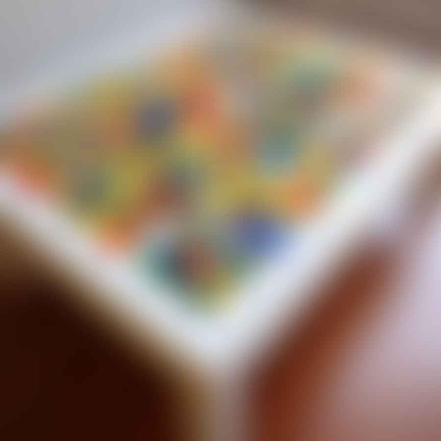 A Lego table with built-in storage filled with colorful Lego bricks