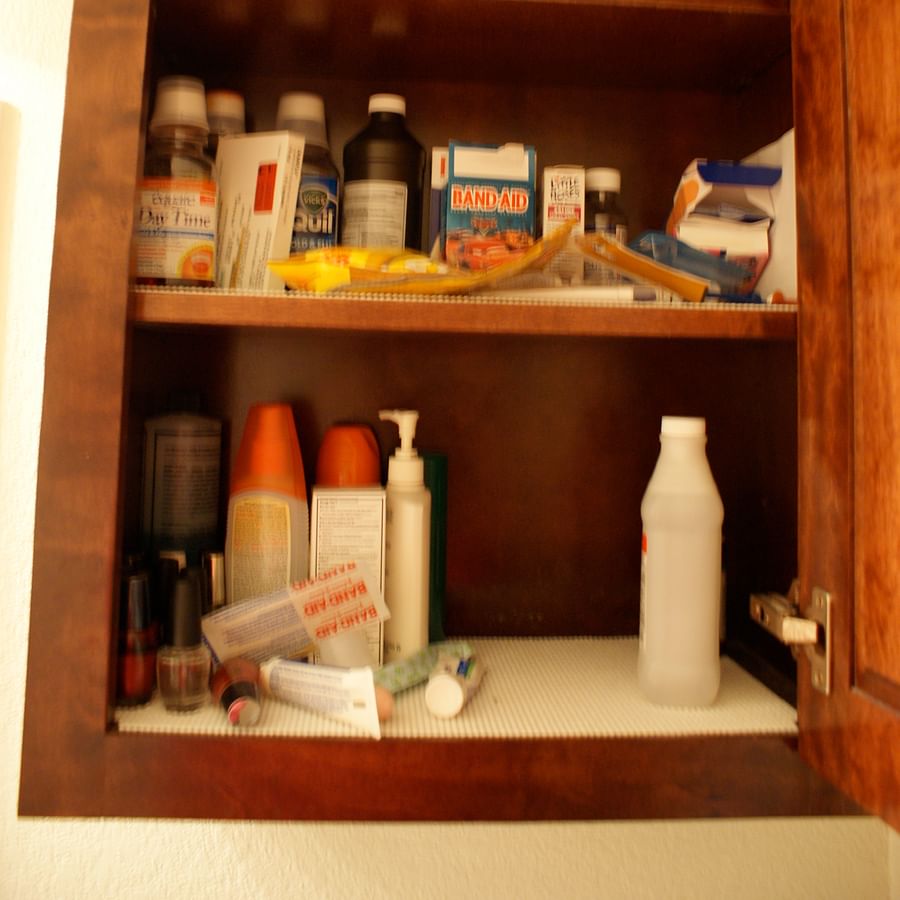 Messy medicine cabinet with expired medications