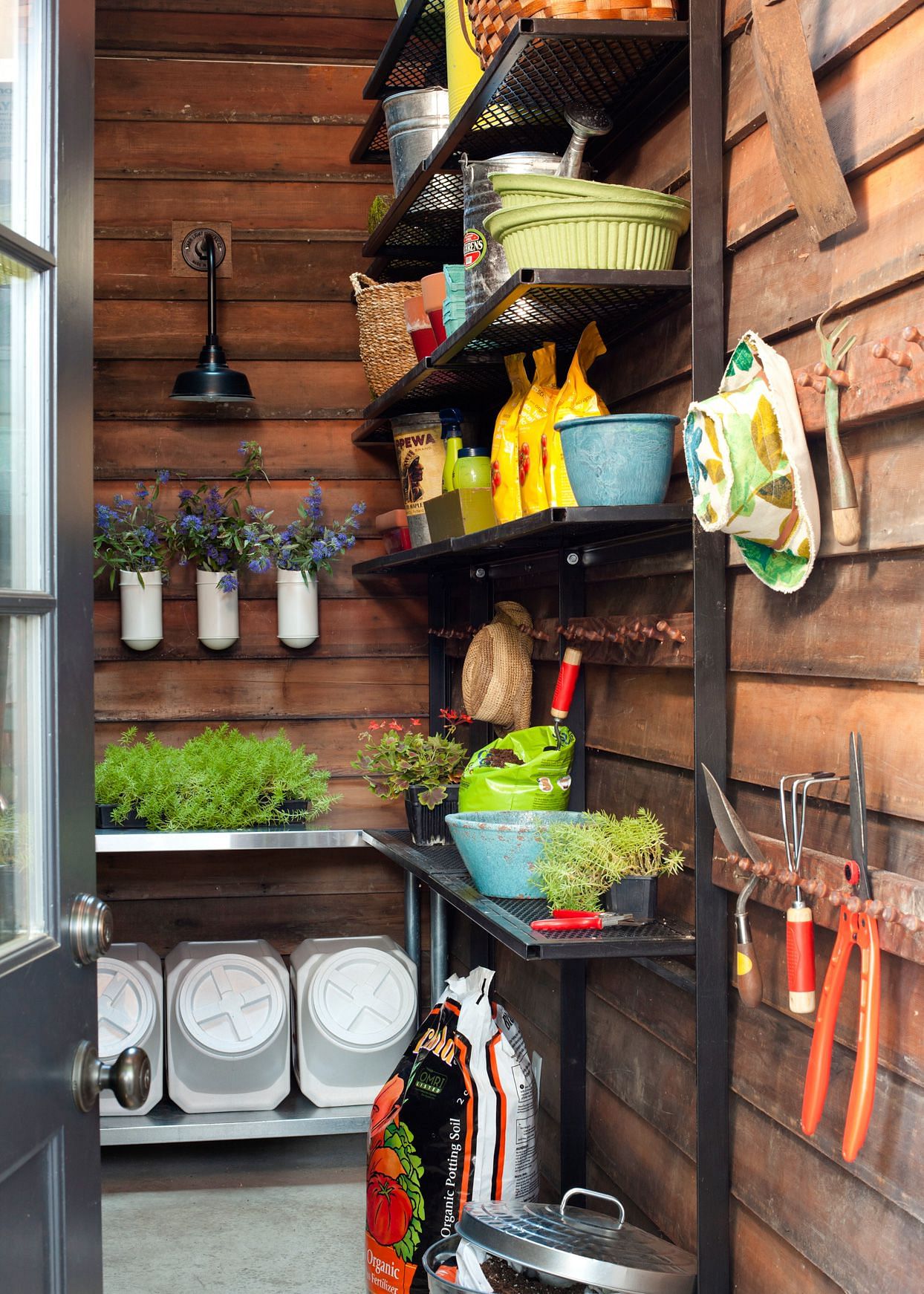 Vertical shelves and hooks in a well-organized shed